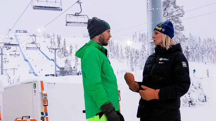 Finn Finnstedt, Teknisk specialist Hybricon och Ulrika Back, VD Svenska Skidspelen AB, samtalar om batteriet som ska ge fossilfri reservkraft.
