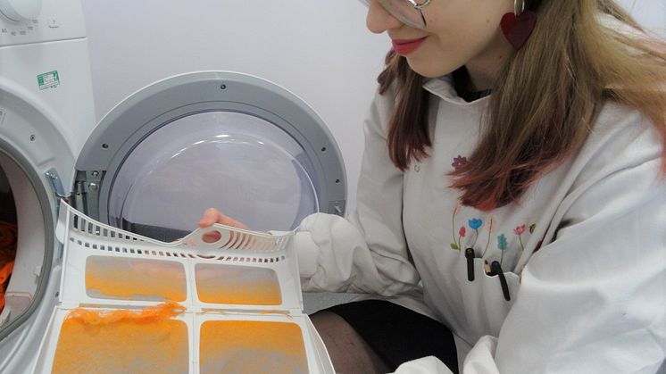 Student Amber Cummins examining microfibers collected on the dryer lint filter
