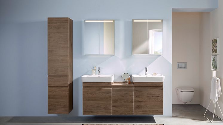 Møbler med trestruktur bidrar til at badet føles hjemmekoselig og innbydende. De varme fargene skaper et lunt inntrykk.