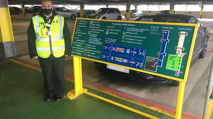 Haywards Heath - staff member Sam Huggett next to tactile map on level 2 of car park