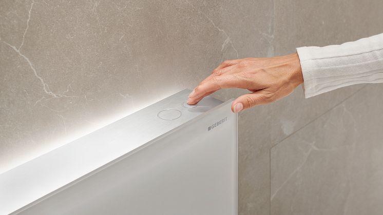 2023_wc category_monolith plus_comfortlight_icon white matt_closeup electronic actuator buttons with hand _Original