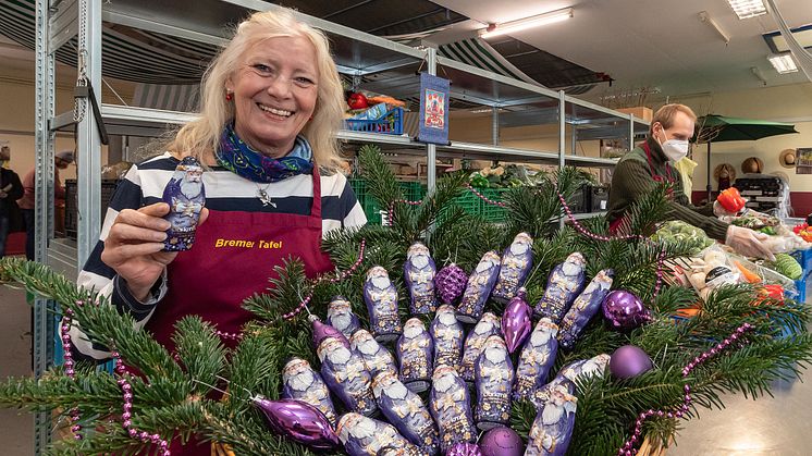 Eine Mitarbeiterin der Tafel in Bremen freut sich über die zarte Aufmerksamkeit von Mondelēz International und Milka.  Bildrechte: Mondelēz International.