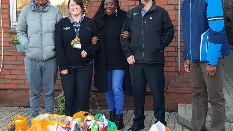 Croydon Community Food Bank volunteers Amatare Oki (far right) and Hakeem Seriki (far left) visited the Selhurst depot with Project Manager Fatima Koroma (middle)