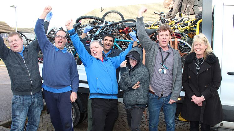 TAG Bikes Employment Skills Worker Robert Bierton (right) and members of the workshop take delivery of abandoned station bikes from GTR distribution manager Sarah Collett (far right)