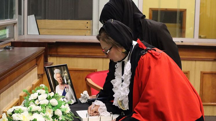 The Mayor of Bury, Councillor Shaheena Haroon, signs the Book of Condolence