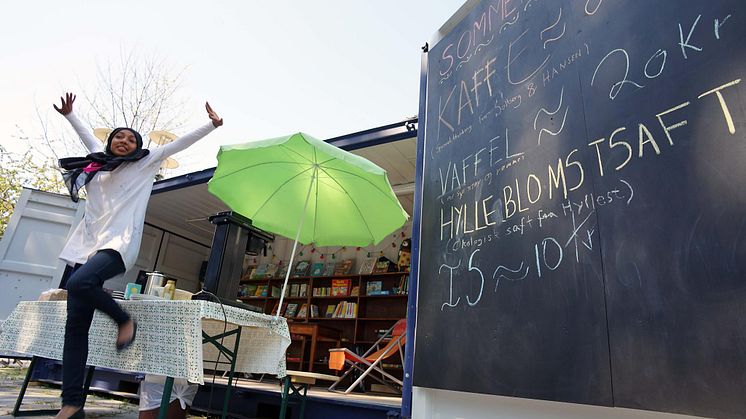 Amber er en av ungdommene som har fått sommerjobb i Deichman. Her selger hun kaffe og vafler på sommer-biblioteket på Schous plass.