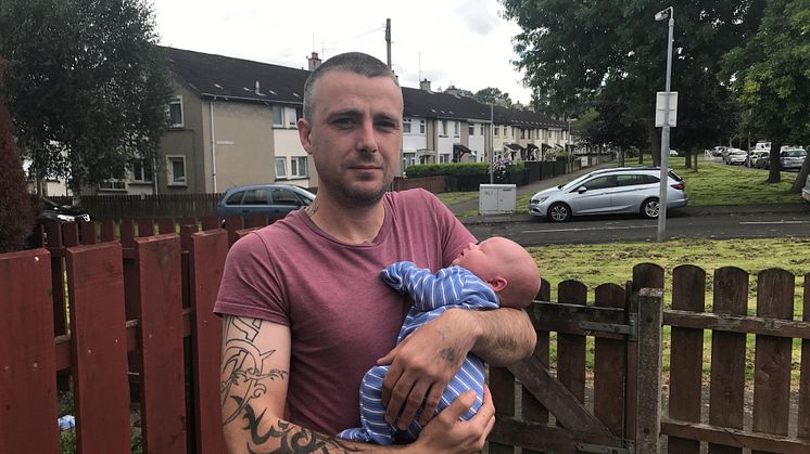 Stroke survivor Connor Shevlin at his home in Belfast holding his four week old son baby Aidan