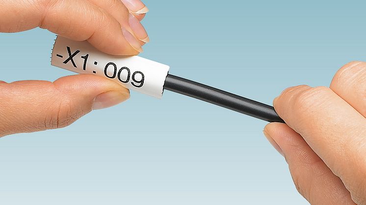 Self-securing conductor and cable marking with oval marking sleeve