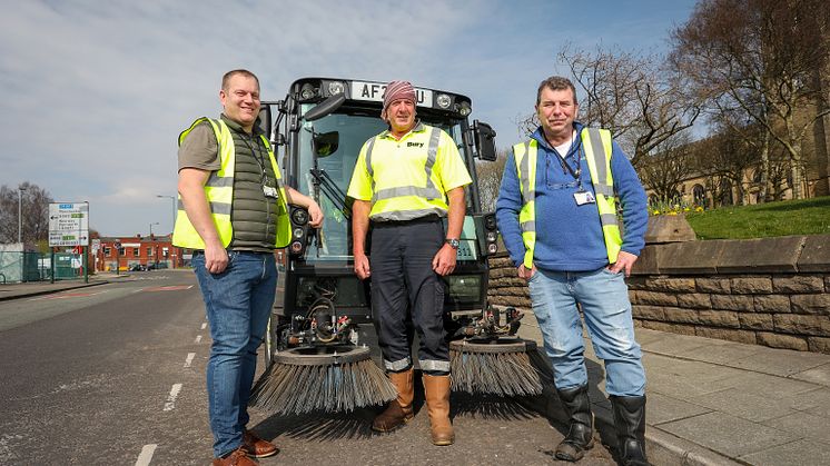 Cllr Quinn with one of the new street sweepers and members of the street care team.
