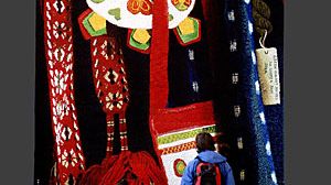 Folk Costume Details - en bildvävnad i storformat  visas på Nordiska museet