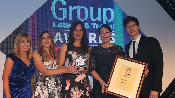(L-R) Maureen Quinn of ‘Just for Groups!’ presents Sophie Thomas, Sales Executive – Groups, Hayley Walker, Sales Assistant – Groups and Ellie Fulcher, Sales Manager – Groups with the trophy alongside special guest and co-host, Magician Ben Hanlin.