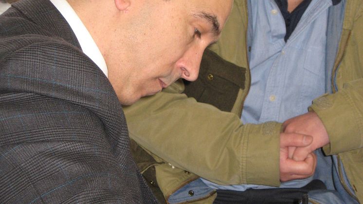 LON 02/15 HMRC NMW Officer at work during NMW operation.