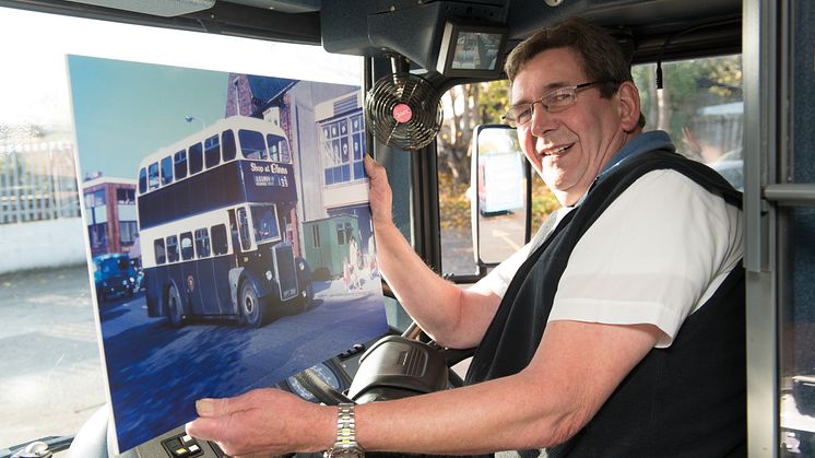 Andrew holding an image of the first bus he drove, at the start of his 43 year career on the buses.
