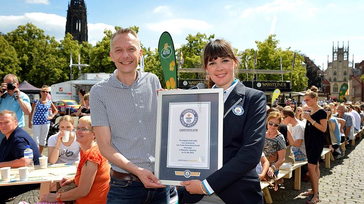 Lena Kuhlmann, Schiedsrichterin von GUINNESS WORLD RECORDS®  überreicht Tino Gottschalk, Geschäftsführer von Arla Foods Deutschland, die offizielle Urkunde. 