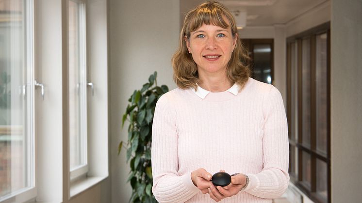 Bildtext: Swedacs bedömningsledare Sophie Svensson med en radonmätare som används för mätning av radon i inomhusluft.