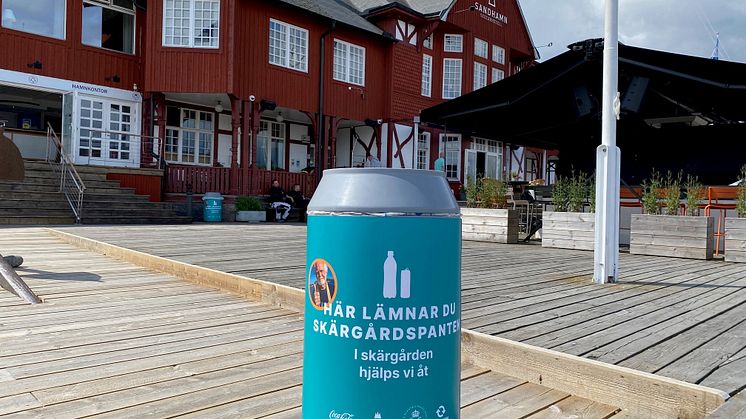 Bild på pantkärl framför ett rött hus