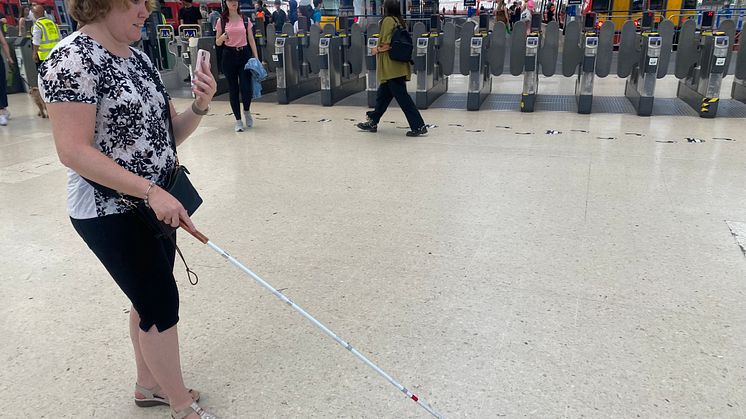 Linn Davies is guided through Brighton station using the Aira app