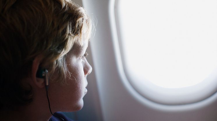 A child looking out his airplane window