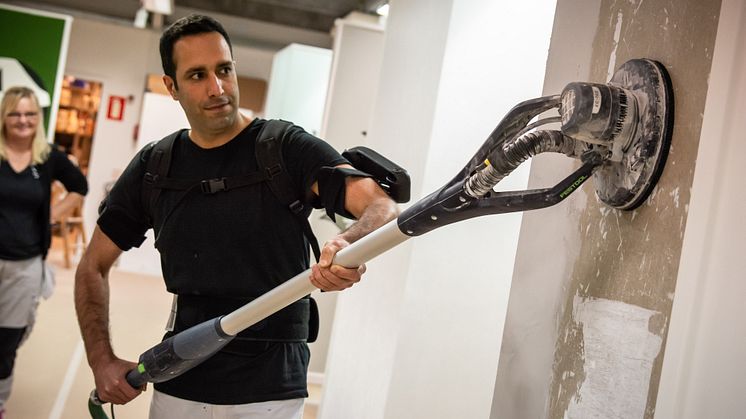 Hamid demonstrerer hvordan et exoskelet kan hjælpe håndværkere med de tunge løft.