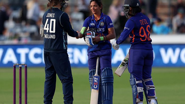 Amy Jones with Harmanpreet Kaur and Harleen Deol after India's win. Photo: Getty Images
