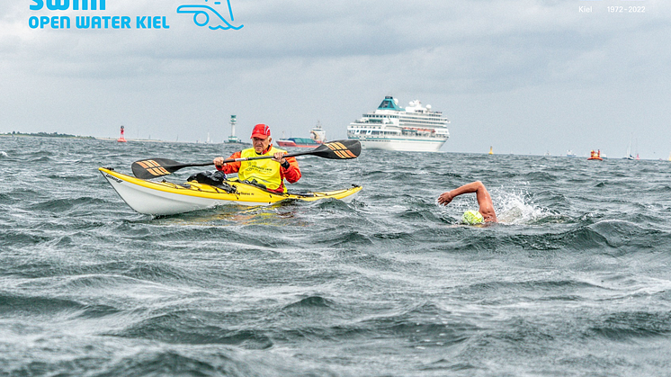 Die Schwimmer:innen werden von den Paddelbooten sicher durch die Kieler Förde begleitet.