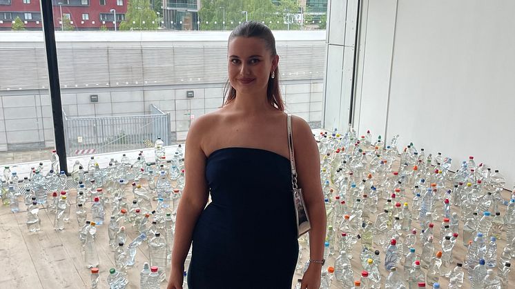 Northumbria University graduate Alice Kershaw is pictured with her work, Discarded Bottles.