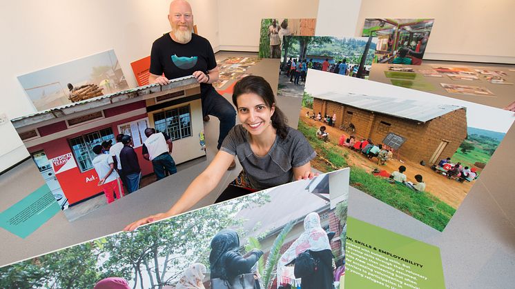 Professor Matt Baillie Smith and Dr Bianca Fadel help install the RYVU exhibition at Gallery North.