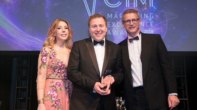 Stephen King (centre) collects his award from comedian and host Katherine Ryan and from sponsor Paul Carr, managing director of Stopgap