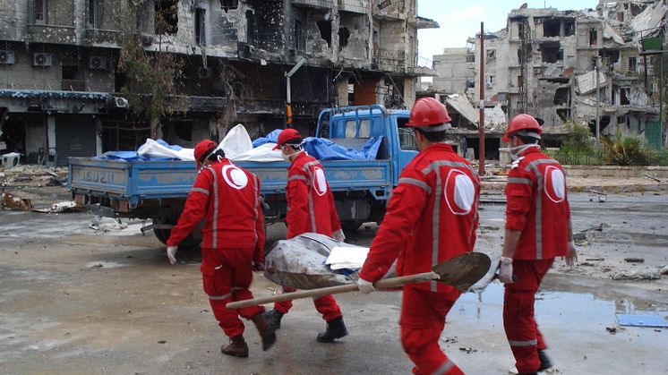 Syrian Arab Red Crescent volunteers retrieving bodies from the streets of Aleppo.