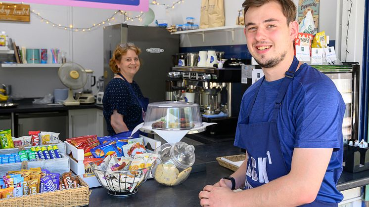Will helps out serving coffee, cakes and other delicacies to local villagers