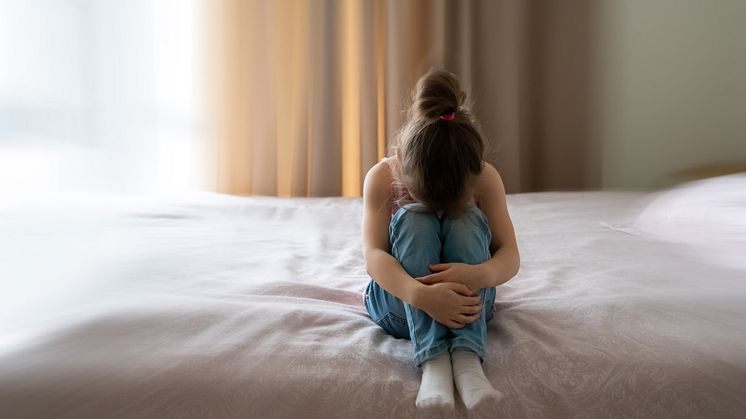 mp56230385-a-little-sad-girl-sitting-on-a-bed-with-motion-blur-effect.jpg
