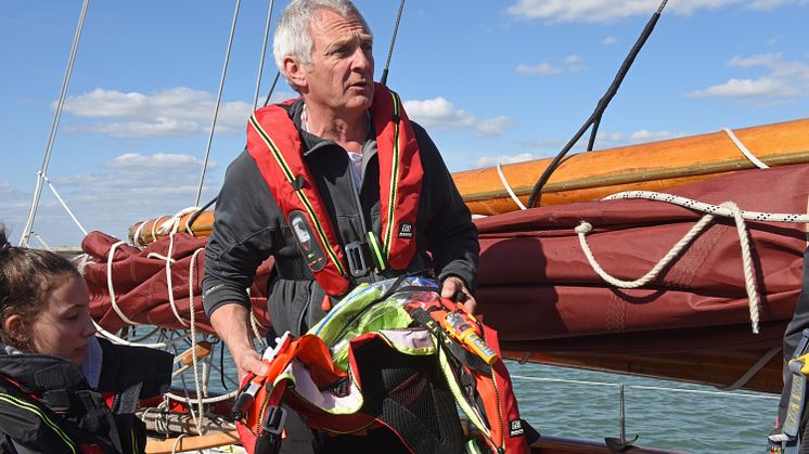 Hi-res image - Ocean Signal - Head of Sailing at Dauntsey’s Toby Marris briefs the Jolie Brise crew about the Ocean Signal rescueME MOB1