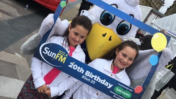 Local youngsters pose with Sunny the Seagull and the Go North East Sun FM bus at the station’s birthday bash 