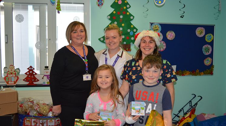 Jeanette Deboo and her daughter Kathryn presented the donations to Janine Standing, play specialist at East Surrey Hospital, and two young patients on the ward. 