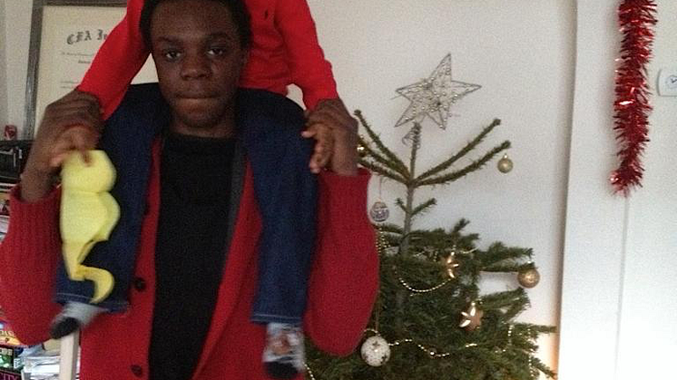 Ola with a child on his shoulders.png