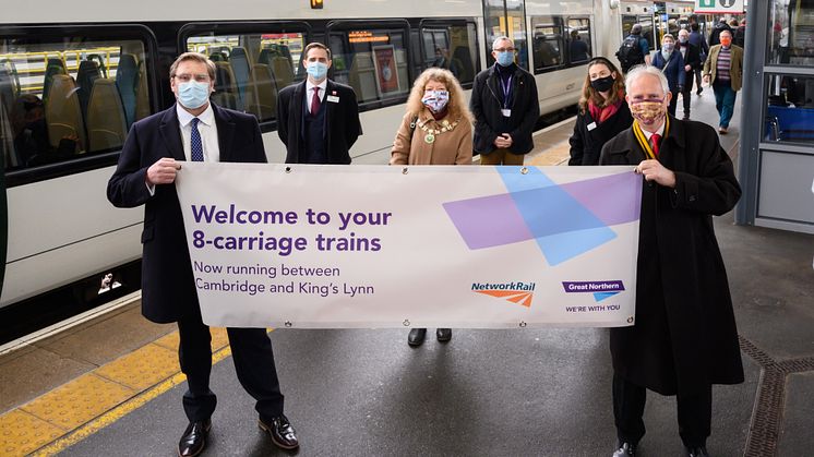Mayor of Cambridgeshire and Peterborough Combined Authority James Palmer (left) holds a banner with Daniel Zeichner MP to celebrate the introduction of longer 8-carriage Great Northern trains between Cambridge and King's Lynn