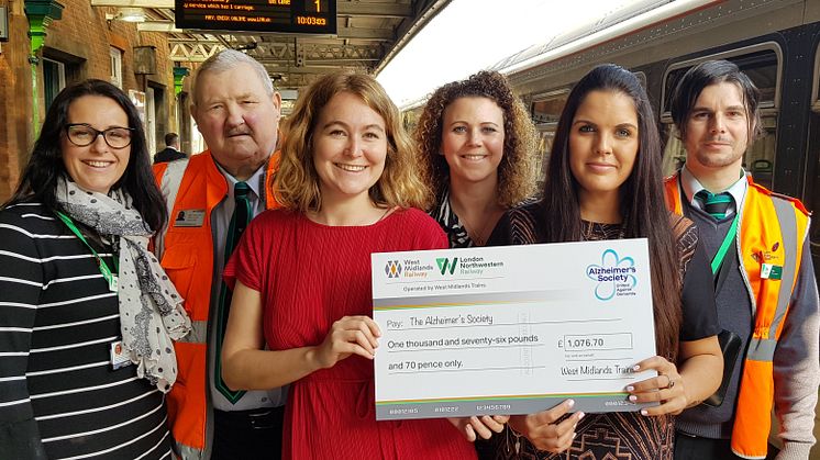 West Midlands Railway and London Northwestern Railway staff hand over the first donation of lost property money to Alzheimer's Society at Nuneaton station