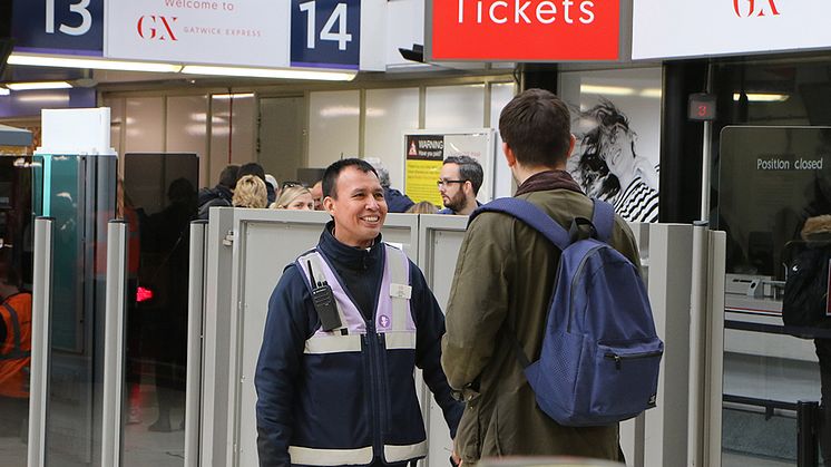 Portal - Customer Service Host Antonio Tapia welcomes a passenger at the Gatwick Express portal at London Victoria