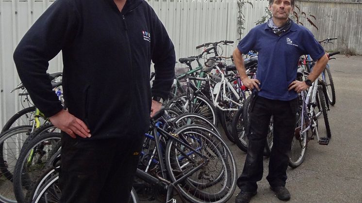 Wheels for wellness: Southern's Dylan Lohman (left) delivers 25 left-behind bikes to Bicycle Technician Paul Horta-Hopkins at SCDA's Newhaven recycling workshop