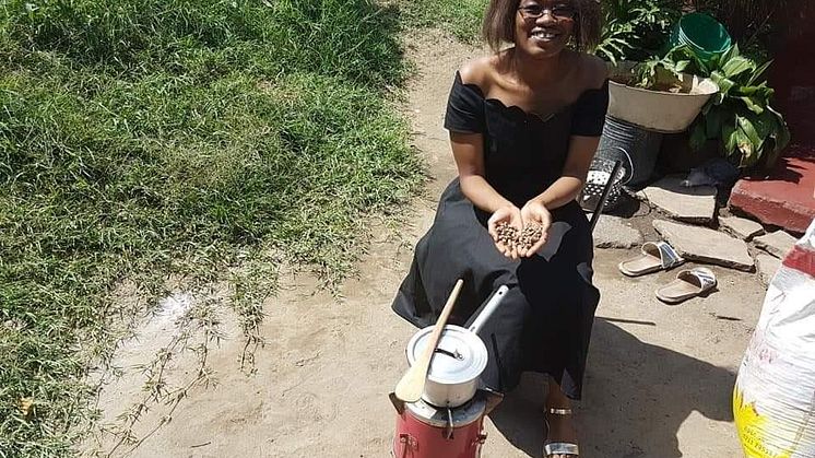 Mukuka Mulenga with sawdust pellets in Zambia 