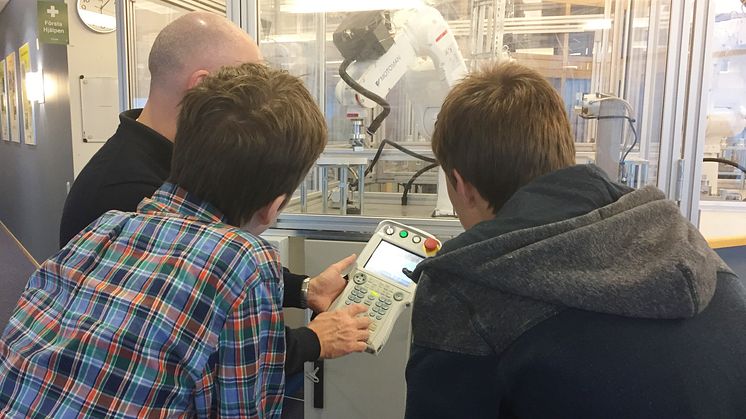 Noggranna instruktioner från Yaskawa Nordics Kenneth Brännmark. Utbildningen sker med säkerhetsinglasade robotar, PLC-styrda.  Foto: Yaskawa Nordic AB.