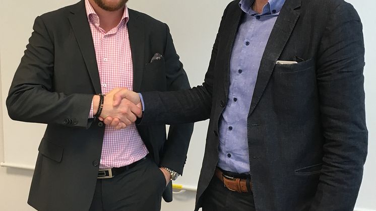 Magnus Hedlund, vd Accountor, och Johan Möller, vd Svensk Markservice, tar i hand efter att avtalet är underskrivet.  