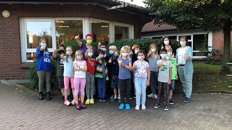 Umweltclownin Ines Hansen (hinten Mitte) und Kleckens Ortsbürgermeisterin Anke Grabe (r.) zu Besuch in der Grundschule Klecken.