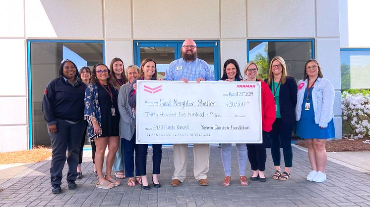 Doug Belisle of the Good Neighbor Homeless Shelter receives a donation from Yanmar America’s Community and Events Committee at a ceremony at Yanmar’s Adairsville Headquarters.