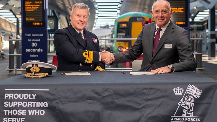 Rear Admiral Phil Hally CB MBE, Assistant Chief of the Defence Staff, and Patrick Verwer, CEO of Govia Thameslink Railway, sign the agreement. More images below.