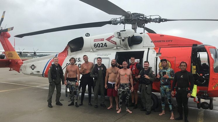 US Coast Guard Fifth District Command Center personnel with the fishermen saved this summer off Cape Henry. Credit: USCG