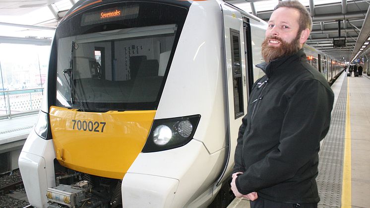 Newly-qualified Thameslink driver Paul Butler alongside the first train he drove from Blackfriars