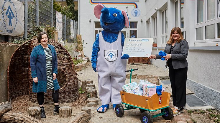 Andrea Mayer, Markenmanagerin von babylove (rechts), übergibt den Spendenscheck Doris Möller-Espe (links), Geschäftsführerin des DKSB Ortsverbandes Pforzheim Enzkreis e. V., und dem Maskottchen der Kinderhäuser.