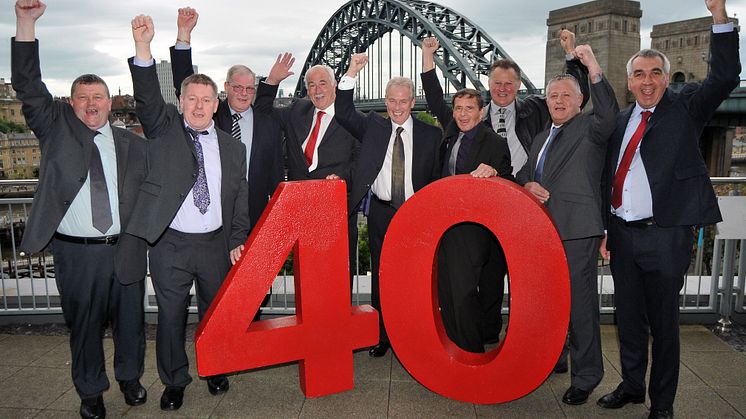  L-R: Robert Harvey, David Tone, Gary Manning, Stephen Millen, Kevin Carr, William Brown, Malcolm Birkett, David Robinson, Barry Newton, in front of the iconic Tyne Bridge.