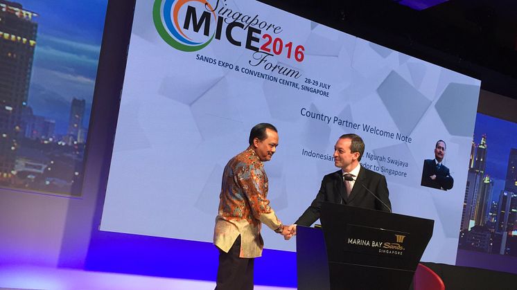 Mark Laudi welcomes the Indonesian Ambassador on stage ...shortly before dashing off to record eventv programs outside the plenary hall. Photo credit: Andrew Vine, The Insight Bureau